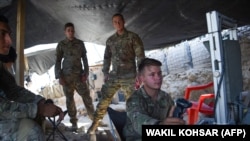 U.S. Army soldiers from NATO looks on as they use a cruise system in a checkpoint during a patrol against militants at the Deh Bala district in the eastern province of Nangarhar.