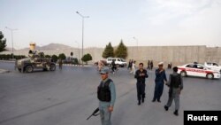 Afghan policemen arrive near the site of a blast in Kabul on July 15.