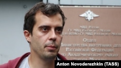Roman Dobrokhotov leaves a police station in Moscow following questioning in July.