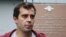 Roman Dobrokhotov leaves a police station in Moscow following questioning in July.