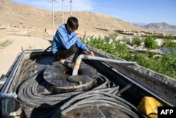 An Afghan boy fills a potable-water tanker from a pump on the outskirts of Kabul. (file photo)