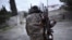 A soldier with separatist forces in Nagorno-Karabakh carries weapons in Martakert province, which was reportedly affected by recent clashes over the breakaway Caucasus region. 