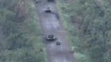 A combat ground drone from Ukraine's Fifth Brigade maneuvers around destroyed armored vehicles as it prepares attacks on Russia's positions.
