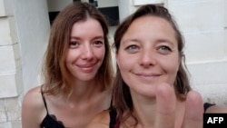 This photo taken in 2020 shows French teacher and trade unionist Cecile Kohler (right) and her sister Noemie in Rochefort, in western France.