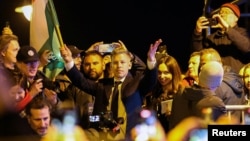 Peter Magyar, leader of the opposition Tisza party, celebrates victory in Hungary's parliamentary vote on April 12.