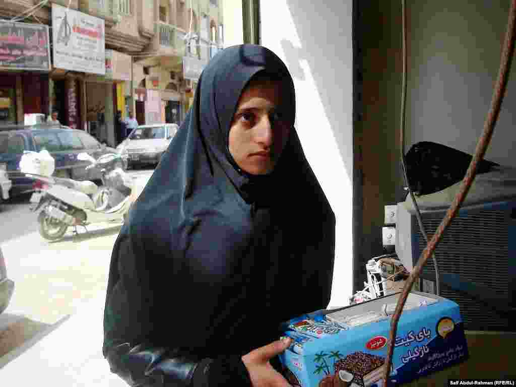 An adolescent girl sells sweets in the Iraqi city of Kut.