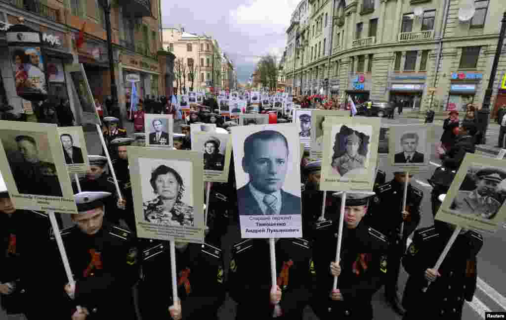 Russian cadets whose relatives fought in World War Two carry their portraits during a parade in St. Petersburg on May 5. (Reuters/Alexander Demianchuk)