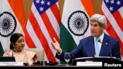 India - U.S. Secretary of State John Kerry (R) gestures as India's External Affairs Minister Sushma Swaraj looks on during their joint news conference in New Delhi, India, August 30, 2016