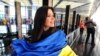 Singer Ruslana Lyzhychko of Ukraine holds a Ukrainian national flag during an interview with AFP at the State Department in Washington in March.