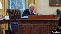U.S. President Joe Biden speaks by phone with Ukrainian President Volodymyr Zelenskiy in the Oval Office at the White House in Washington.
