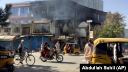 Damaged shops are seen after fighting between the Taliban and Afghan security forces in Kunduz city on August 8.