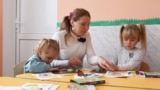 Moldova: Children and their teacher at the kindergarten in the village of Coșeni