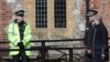 British Prime Minister Theresa May talks with local police officials in Salisbury.