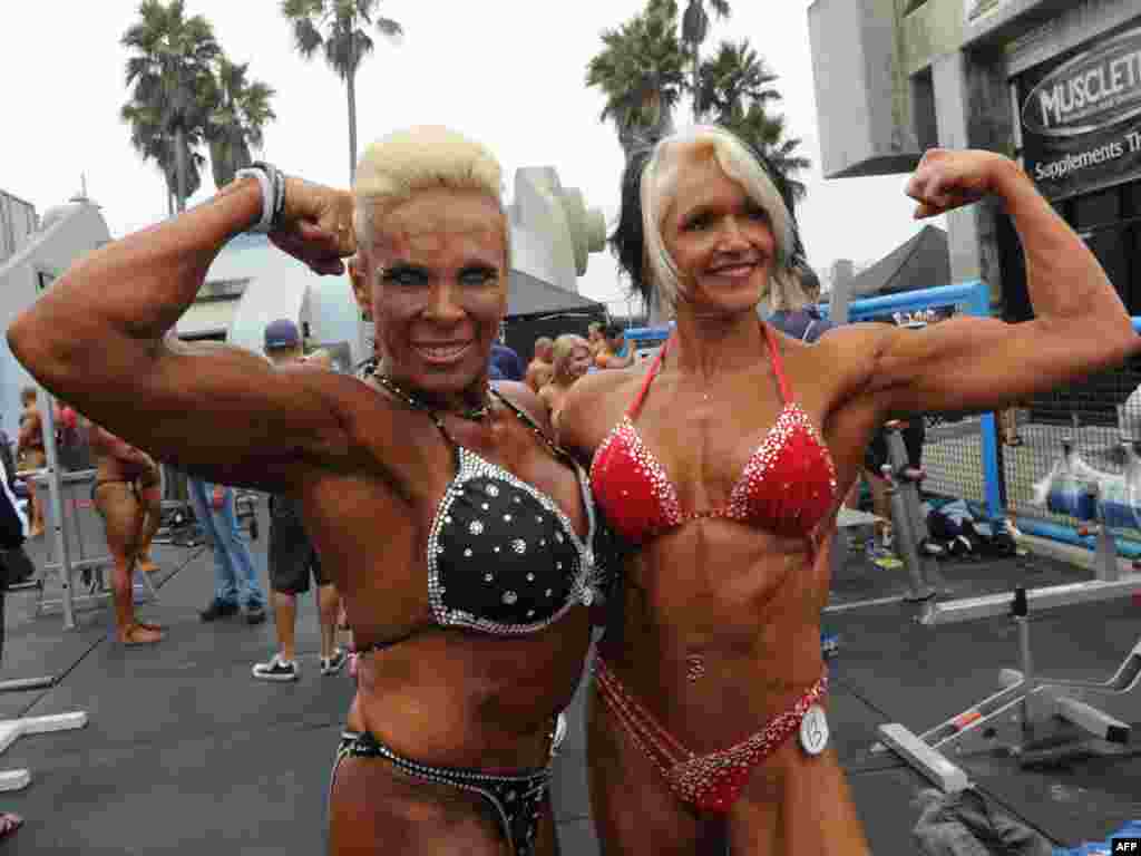 Bodybuilders Lauren Powers (left) and Maire Brandon pose before they compete during the annual Muscle Beach Championship bodybuilding and bikini competition at Venice Beach in Los Angeles on September 6. Photo by Mark Ralston for AFP