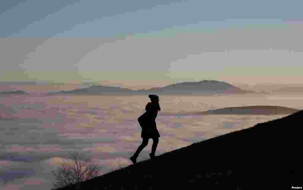 A woman walks on the Smetovi mountain range near Zenica, Bosnia-Herzegovina. (Reuters/Dado Ruvic)