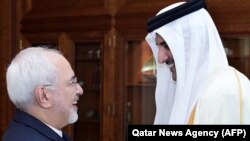 Qatar's Emir Sheikh Tamim bin Hamad Al-Thani (R) greets Iranian Foreign Minister Mohammad Javad Zarif during their meeting in Doha, October 3, 2017