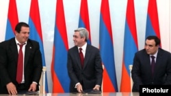 Armenia -- President Serzh Sarkisian (C), Orinats Yerkir Party leader Artur Baghdasarian (R) and Prosperous Armenia Party leader Gagik Tsarukian sign a new coalition agreement, 17Feb2011.