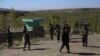 Afghan security personnel guard the site of an attack by Taliban militants on a government compound in Ghazni Province on April 12.