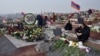 Armenians visit the graves of their relatives killed during the latest fighting over the breakaway Nagorno-Karabakh territory in Yerevan on December 12.