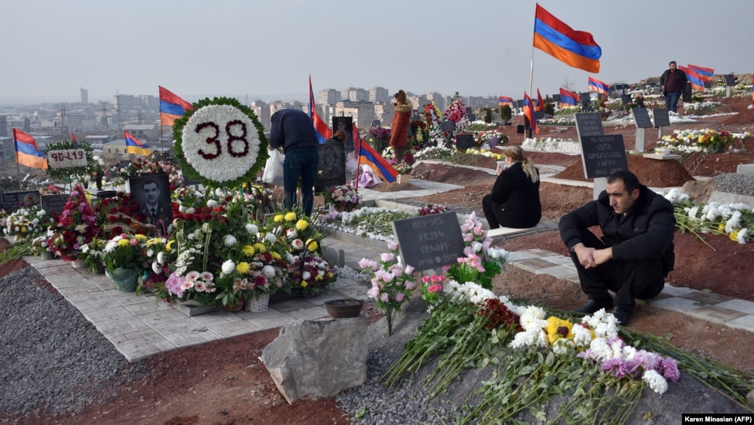 Armenians visit the graves of their relatives killed during the latest fighting over the breakaway Nagorno-Karabakh territory in Yerevan on December 12.