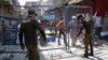 Police officers put up barriers as they guard a street sealed after authorities reimposed lockdowns in selected areas in an effort to stop the spread of the coronavirus disease in the eastern city of Lahore on June 17.