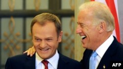 U.S. Vice President Joe Biden (right) shares a lighter moment with Polish Prime Minister Donald Tusk during their meeting in Warsaw on October 21.