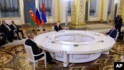 Russian President Vladimir Putin, center, Azerbaijani President Ilham Aliyev, left, and Armenian Prime Minister Nikol Pashinyan attend a trilateral meeting in Moscow, May 25, 2023.