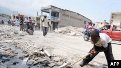 A boy drinks from a broken pipe on the street of the Haitian capital, Port-au-Prince, in the aftermath of the massive January earthquake.