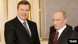 Ukrainian President Viktor Yanukovych (left) shakes hands with Russian Prime Minister Vladimir Putin during his working visit to Kyiv in October. Is Russia the model Yanukovych's government aspires to bring to Ukraine?