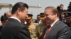 Chinese President Xi Jinping (L) is welcomed by Pakistani Prime Minister Nawaz Sharif after arriving in Islamabad in April.