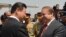 Chinese President Xi Jinping (L) is welcomed by Pakistani Prime Minister Nawaz Sharif after arriving in Islamabad on April 20.