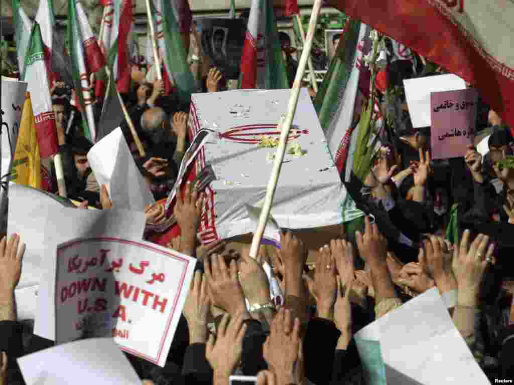 People take part in the funeral of Sanee Zhaleh, a student who was shot dead during an opposition rally two days before in Tehran on February 16. Iranian government supporters have clashed with pro-opposition people during the funeral.Photo by Reuters