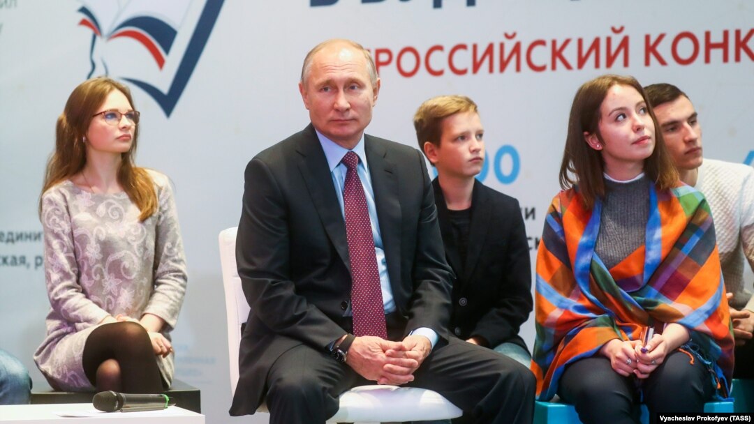 Russian President Vladimir Putin meets with students, authors of the best essays on the topic of "Russia Focused On The Future" in Moscow on January 11.