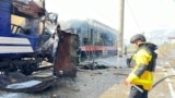 A firefighter by a passenger train hit by a Russian drone strike in Shostka, October 4, 2025, in a photo provided by Ukrainian police 