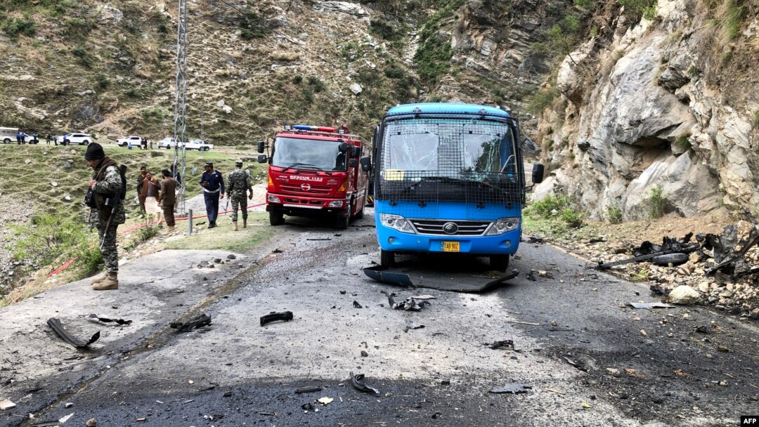 Pakistani security personnel inspect the site of a suicide attack in Khyber Pakhtunkhwa Province on March 26 that killed five Chinese engineers and a Pakistani driver.