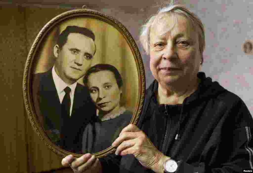 Alla Kanatush, 78, holds a photo of her and husband Uladzimer, in Minsk on October 23, 2013. Uladzimer Kanatush was arrested at the end of 1949 and sentenced to 25 years in a labor camp, but survived and returned home after Stalin's death.