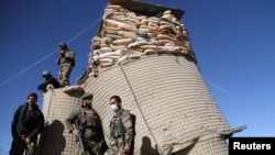 Afghan soldiers stand guard at the checkpoint in Khwaja Omari district of Ghazni Province on April 12.