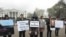 Protest organizer Natalia Pelevine wears a prisoner costume in front of the White House at a "Strategy 31"-inspired rally in Washington.