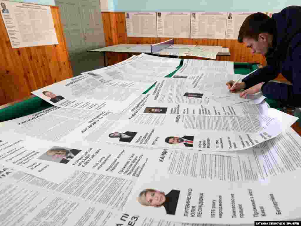 An election observer signs a protocol during the Ukrainian presidential elections in the village of Velyki Dmytrovychi, some 40 km south of Kyiv. (EPA-EFE / Tatyana Zenkovich)