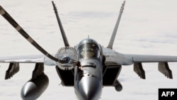 A F/A-18E Super Hornet assigned to the “Eagles” of Strike Fighter Squadron (VFA) 115 conducts aerial refueling operations with a US Air Force KC-10A Extender over the Pacific Ocean, February 26, 2017