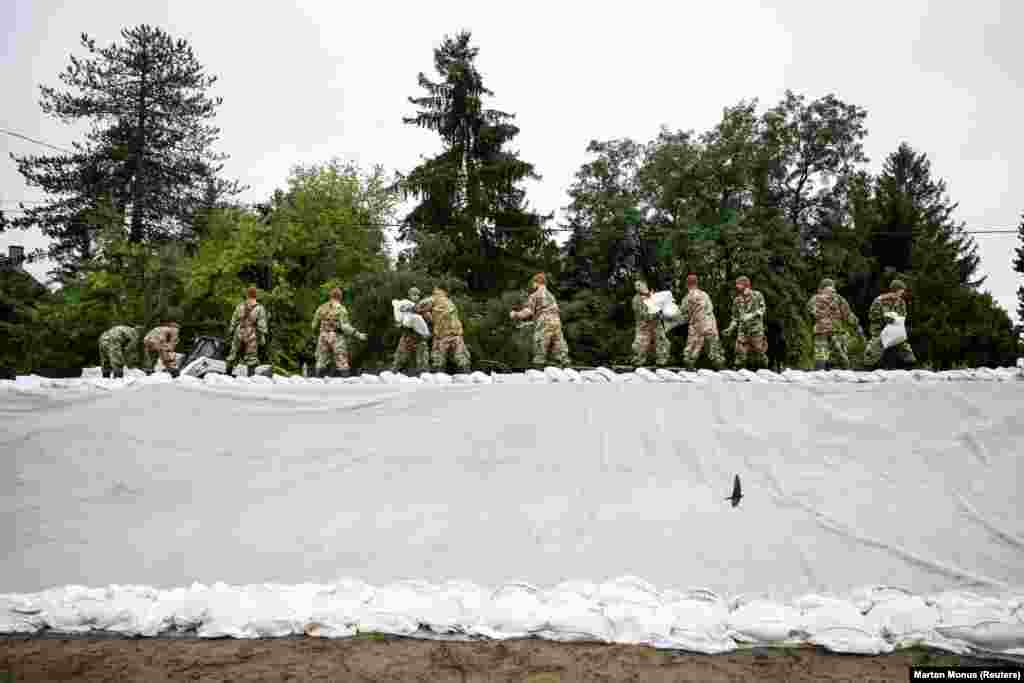 Soldiers carry sandbags to strengthen the dam along the Danube in Pilismarot, Hungary.