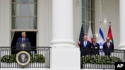 U.S. President Donald Trump (left) speaks during the Abraham Accords signing ceremony in Washington in September 2020 while Israeli Prime Minister Benjamin Netanyahu, United Arab Emirates Foreign Minister Abdullah bin Zayed al-Nahyan, and then-Bahraini Foreign Minister Khalid bin Ahmed Al Khalifa look on.