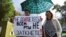 A woman holds a placard reading "You can't shut up everyone!" as journalists and supporters take part in a protest against Russia's "foreign agent" law in Moscow in September.
