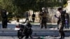 Afghan security forces inspect the site of a suicide attack in Kabul on September 9