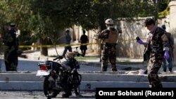 Afghan security forces inspect the site of a suicide attack in Kabul on September 9