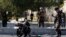 Afghan security forces inspect the site of a suicide attack in Kabul on September 9
