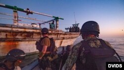 A USS Winston S. Churchill team provides food and water to an Iranian-flagged dhow in distress in the Arabian Sea, Oct. 15.