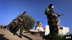 Iranian Kurdish female fighters take part in a training session in Dibis, some 50 kms northwest of Kirkuk, Iraq, September 15, 2014