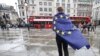 A demonstrator wrapped in a European flag leaves an anti-Brexit protest