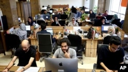 Snapp online taxi company work at their office in Tehran May 23, 2017. Taxi and transportation fares have jumped after a hike in gasoline prices.